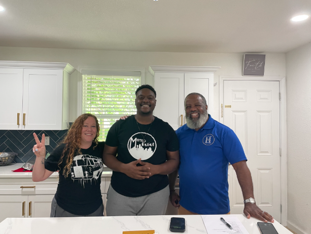 Ivan, whose name has been changed for privacy, celebrates a new chapter with members of the Metro Relief community